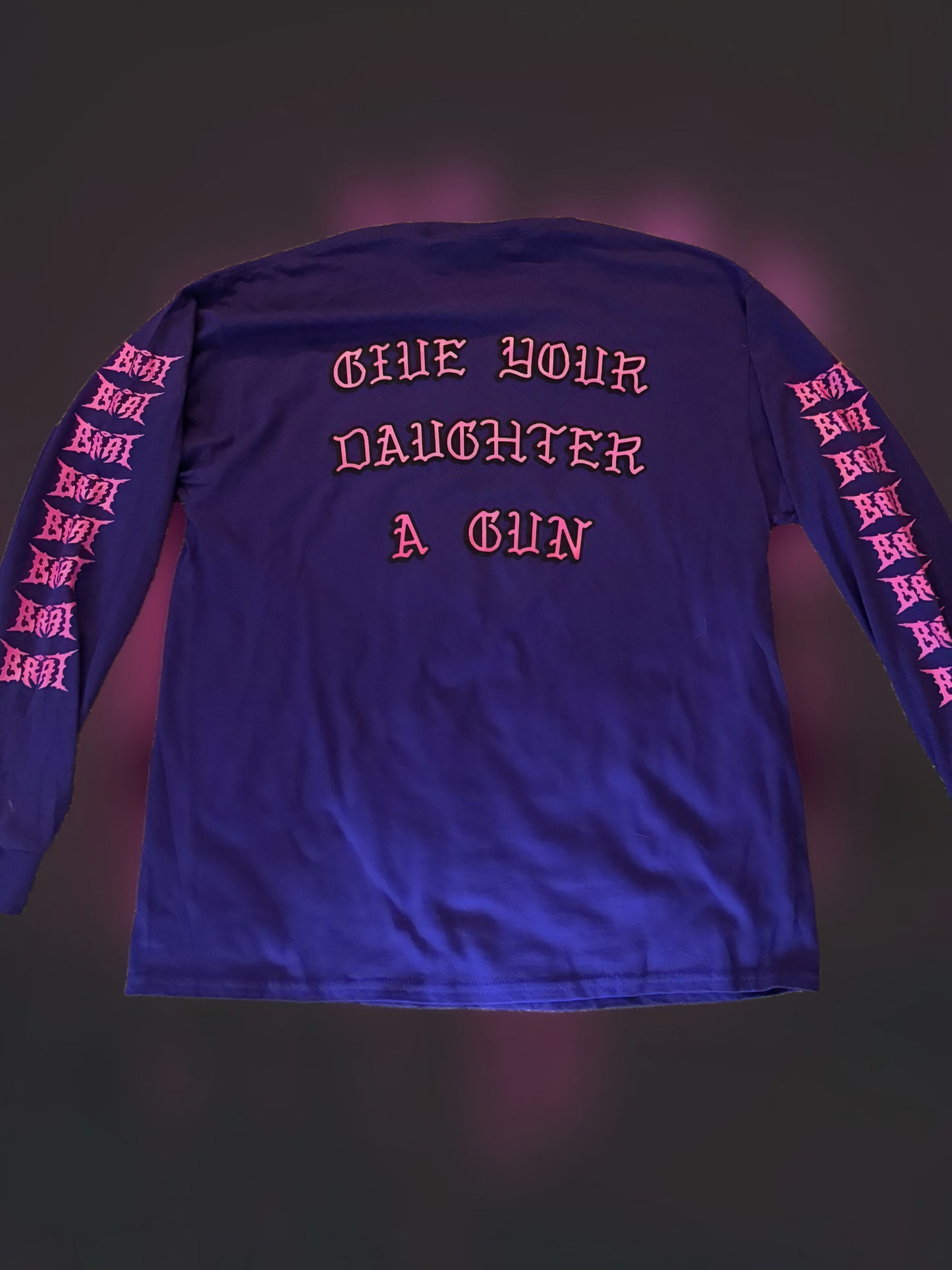 Arm Women tee in dark purple with “Give your daughter a gun” backprint